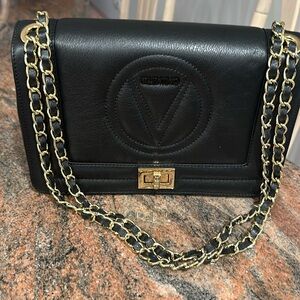 Beautiful Black Valentino bag unworn with black and gold chain straps .